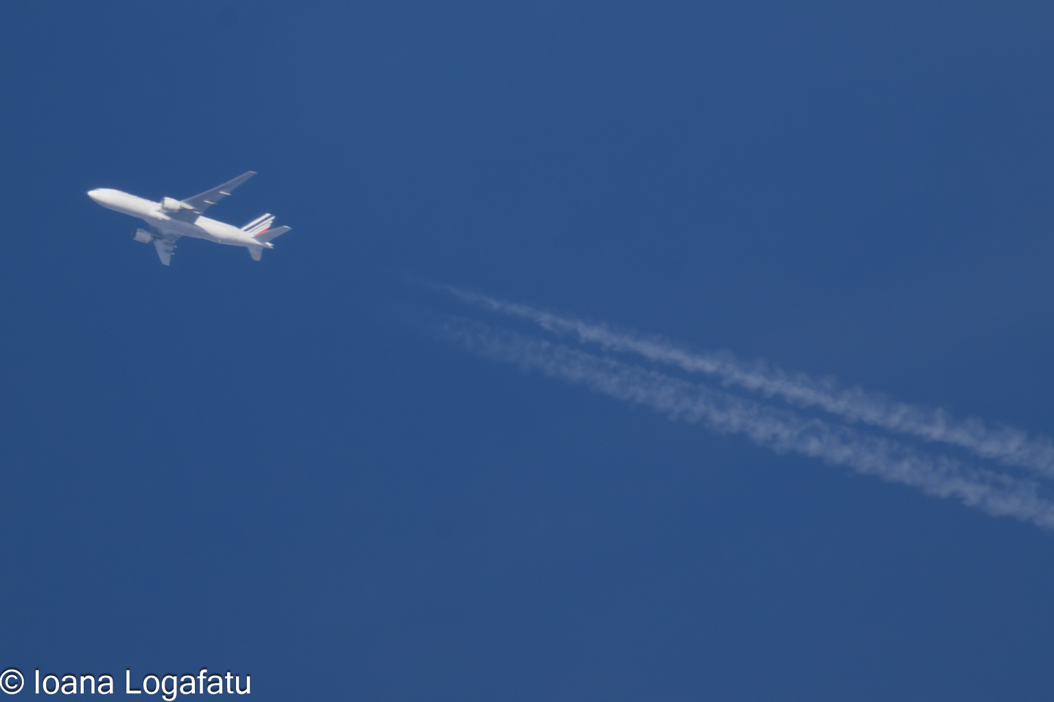 Aircraft soaring high above the clear blue sky